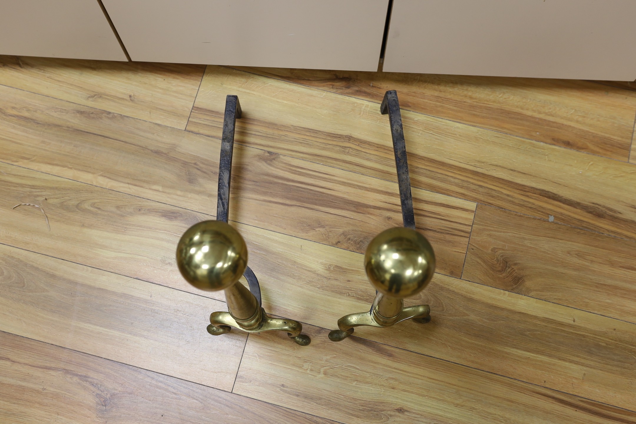 A pair of brass andirons. 57cm high